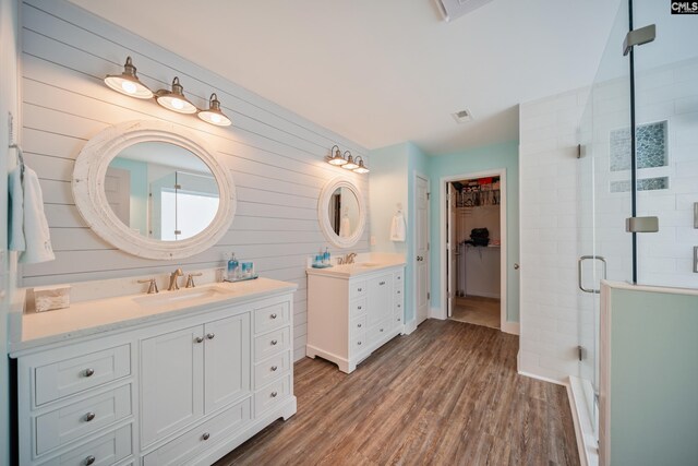 415 Mulberry Ridge Ct, Lexington, SC 29073 - bathroom with a shower stall, wood finished floors, two vanities, wood walls, and a spacious closet
