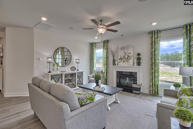 550 Edenwood Dr, Sumter, SC 29150 - living area featuring ceiling fan, a glass covered fireplace, baseboards, wood finished floors, and recessed lighting