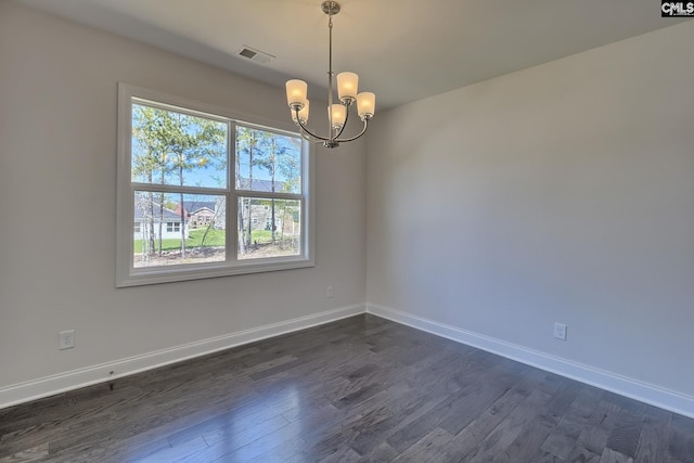 550 Edenwood Dr, Sumter, SC 29150 - spare room featuring dark wood-type flooring, a chandelier, and baseboards