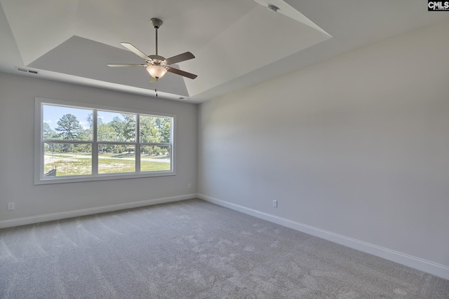 550 Edenwood Dr, Sumter, SC 29150 - spare room featuring a tray ceiling, baseboards, a ceiling fan, and carpet