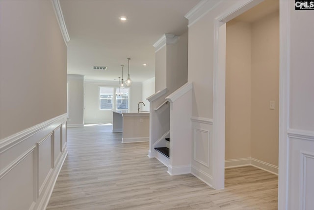 550 Edenwood Dr, Sumter, SC 29150 - hall featuring crown molding, light wood-style floors, recessed lighting, a decorative wall, and wainscoting
