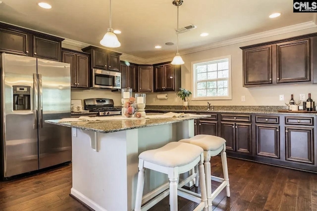 520 Connecticut Ave, Chapin, SC 29036 - kitchen featuring appliances with stainless steel finishes, crown molding, dark brown cabinetry, dark wood-type flooring, and stone counters