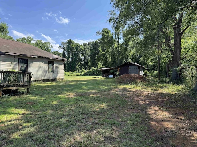382 Fagan Rd, Winnsboro, SC 29180 - view of green lawn with an outdoor structure, a storage unit, and a deck