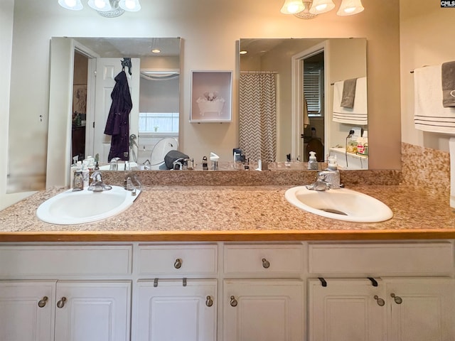 full bath with double vanity and a shower with shower curtain