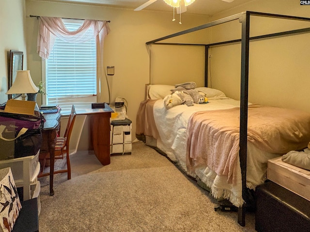 bedroom featuring light colored carpet and a desk