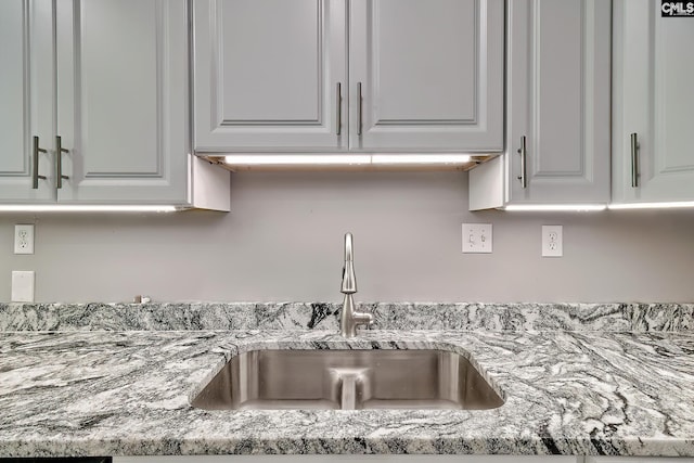 1240 Windmill Rd, Leesville, SC 29070 - kitchen view of a sink, white cabinetry, and light stone counters