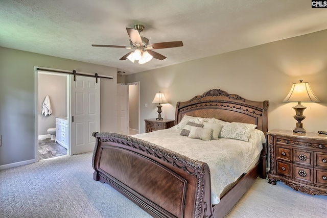 1240 Windmill Rd, Leesville, SC 29070 - bedroom with light carpet, a barn door, connected bathroom, baseboards, and ceiling fan