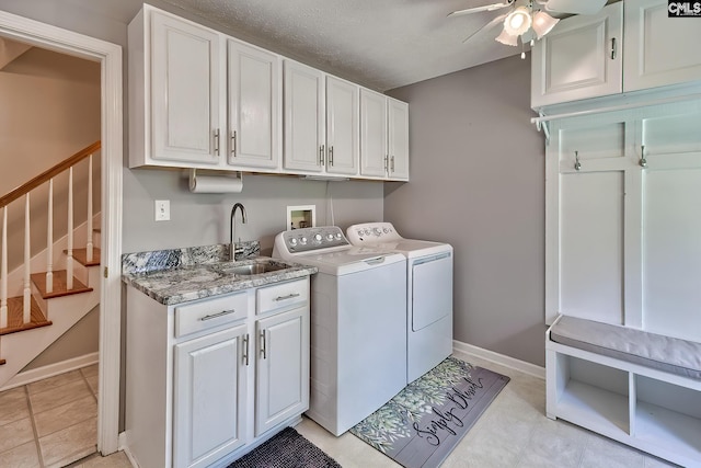 1240 Windmill Rd, Leesville, SC 29070 - laundry area with cabinet space, washer and dryer, ceiling fan, baseboards, and a textured ceiling