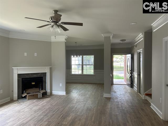 10 Saints Creek Pl, Irmo, SC 29063 - unfurnished living room featuring crown molding, a premium fireplace, ceiling fan, dark wood-style flooring, and baseboards
