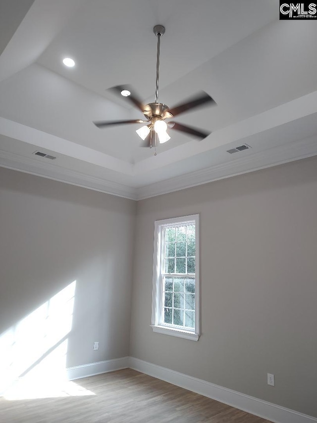 10 Saints Creek Pl, Irmo, SC 29063 - empty room with a tray ceiling, baseboards, ornamental molding, a ceiling fan, and wood finished floors