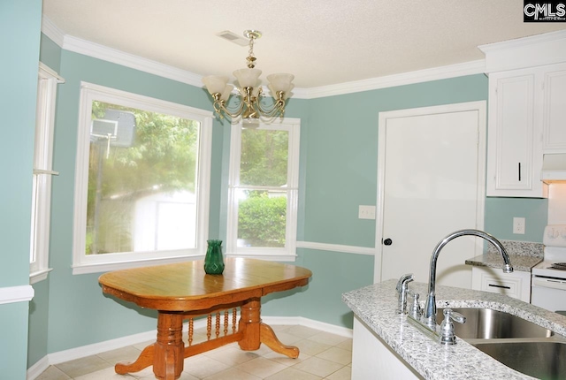 kitchen featuring a sink, white cabinets, a chandelier, crown molding, and light stone countertops
