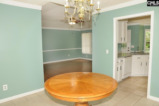 dining room featuring a chandelier, baseboards, light tile patterned floors, ceiling fan, and crown molding