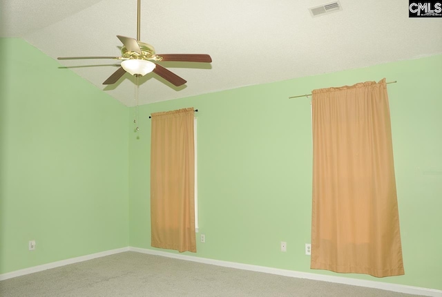 spare room with ceiling fan, carpet floors, baseboards, and vaulted ceiling