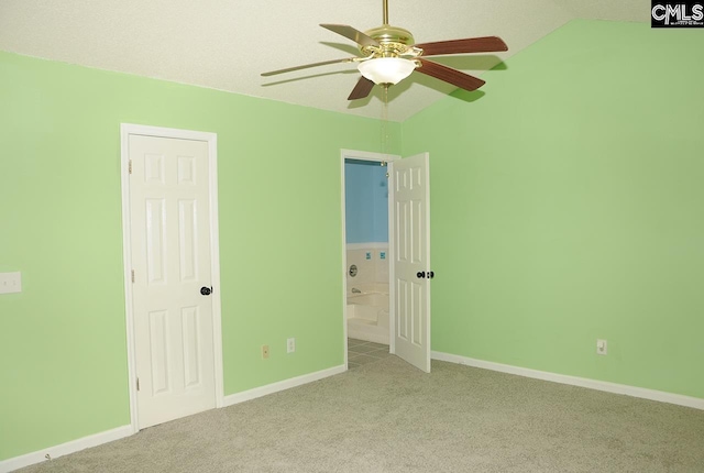 unfurnished bedroom with carpet floors, lofted ceiling, baseboards, and a ceiling fan