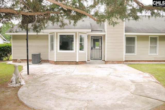 view of front of home with a patio area and central AC