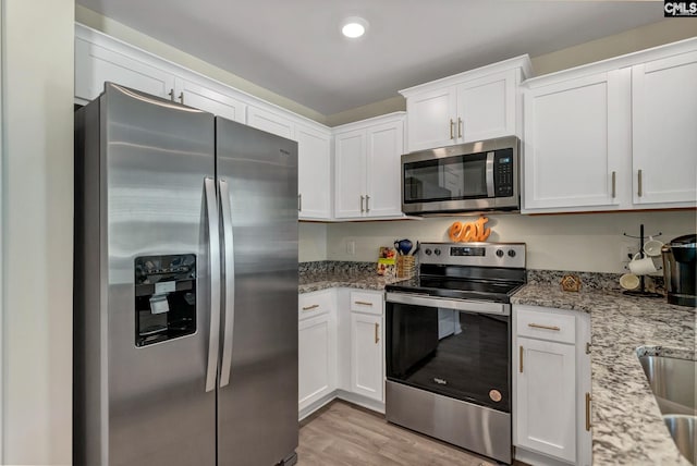 126A Willow Creek Blvd, Lugoff, SC 29078 - kitchen featuring stainless steel appliances, white cabinetry, light wood finished floors, light stone counters, and recessed lighting