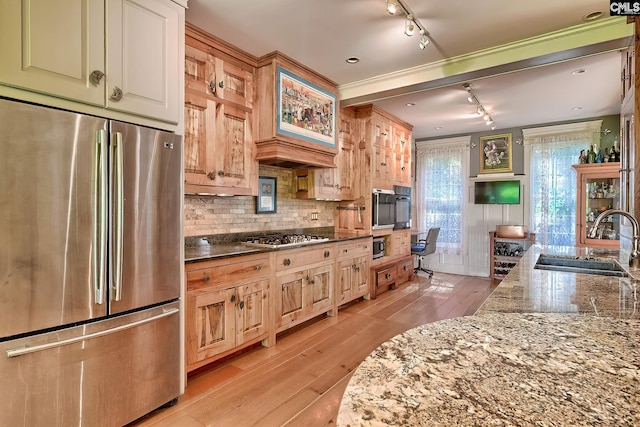 109 Broad Bluff Pt, Irmo, SC 29063 - kitchen featuring stainless steel appliances, a sink, track lighting, light wood finished floors, and dark stone countertops