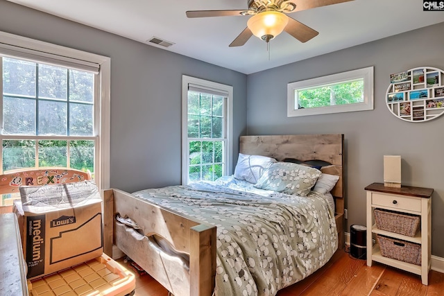 109 Broad Bluff Pt, Irmo, SC 29063 - bedroom with wood finished floors, multiple windows, ceiling fan, and baseboards