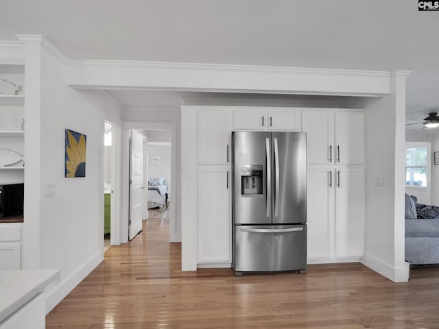 1513 Molly Creek Cir, Ridgeway, SC 29130 - kitchen with stainless steel refrigerator with ice dispenser, light wood-style floors, baseboards, white cabinetry, and black microwave