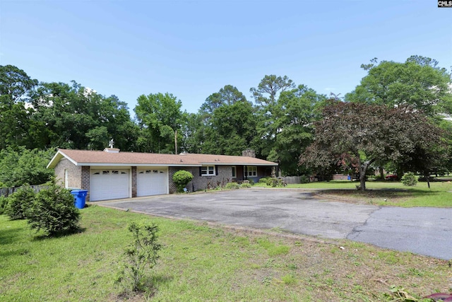 805 Mcrae Rd, Camden, SC 29020 - ranch-style home with a garage, driveway, a chimney, a front lawn, and brick siding