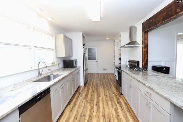 805 Mcrae Rd, Camden, SC 29020 - kitchen featuring wall chimney range hood, appliances with stainless steel finishes, a sink, light wood-style floors, and light stone counters