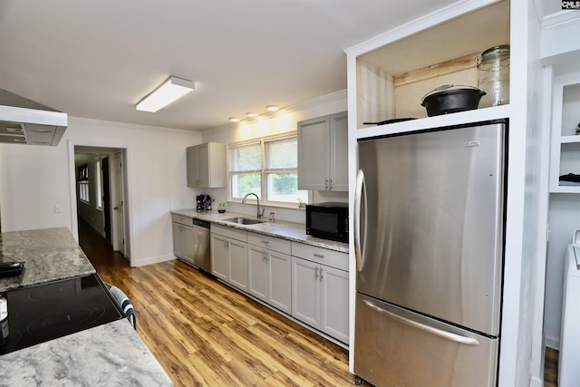 805 Mcrae Rd, Camden, SC 29020 - kitchen with black appliances, a sink, crown molding, light wood-type flooring, and light stone counters