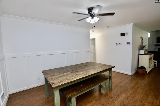 805 Mcrae Rd, Camden, SC 29020 - dining area with ceiling fan, ornamental molding, dark wood-style floors, wainscoting, and a decorative wall