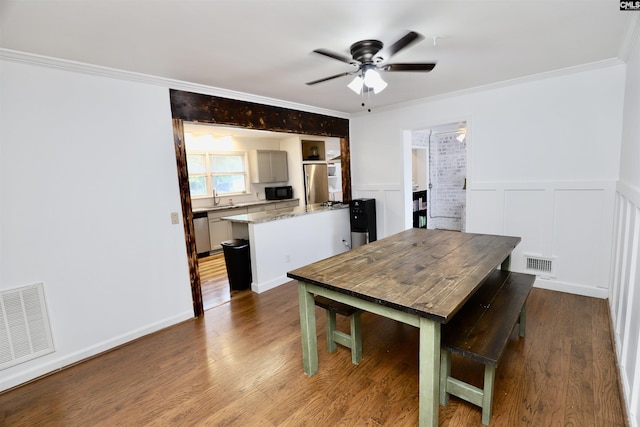 805 Mcrae Rd, Camden, SC 29020 - dining room with a ceiling fan, ornamental molding, wood finished floors, and wainscoting