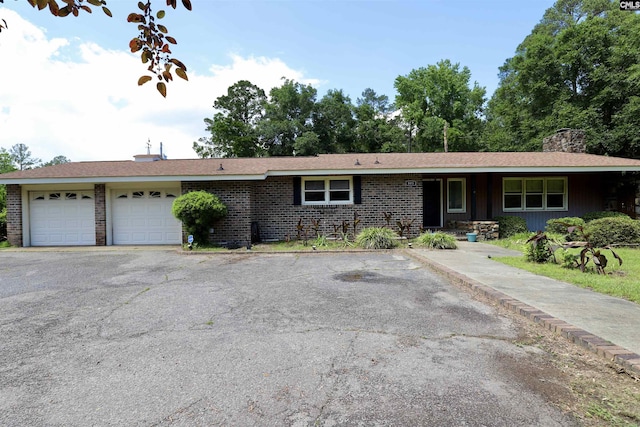 805 Mcrae Rd, Camden, SC 29020 - ranch-style home featuring a garage, a chimney, brick siding, and driveway