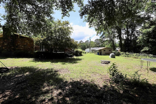 805 Mcrae Rd, Camden, SC 29020 - view of green lawn with a trampoline and a deck