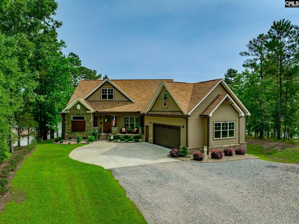 1099 Retreat Way, Ridgeway, SC 29130 - craftsman house with driveway, covered porch, a garage, a front yard, and roof with shingles