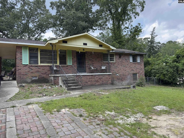 2313 Omega Dr, Columbia, SC 29223 - view of front of home with covered porch, brick siding, crawl space, and an attached carport