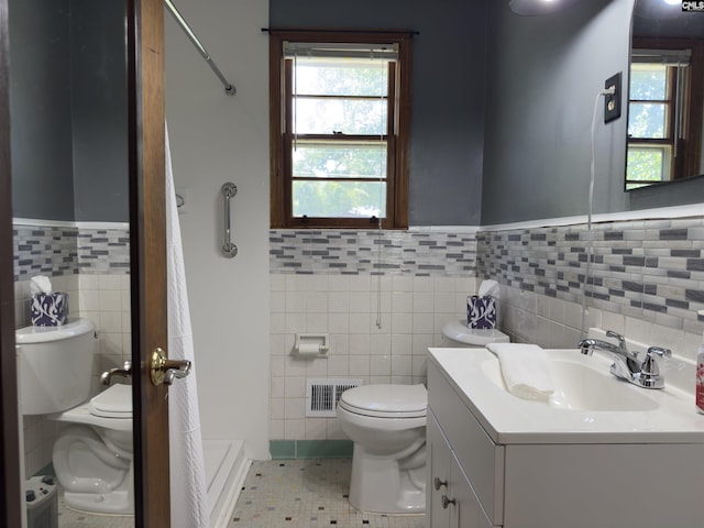 2313 Omega Dr, Columbia, SC 29223 - full bath featuring tile walls, toilet, tile patterned flooring, a wainscoted wall, and vanity