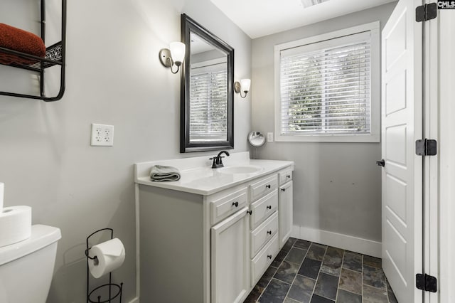 2033 Old Hilton Rd, Chapin, SC 29036 - bathroom featuring baseboards, toilet, stone finish flooring, and vanity
