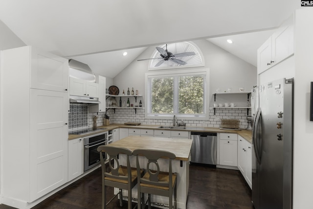 2033 Old Hilton Rd, Chapin, SC 29036 - kitchen with stainless steel appliances, open shelves, butcher block countertops, under cabinet range hood, and dark wood finished floors