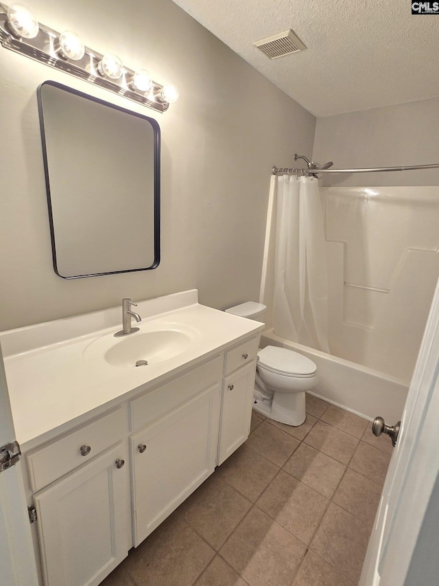 full bath featuring vanity, tile patterned flooring, toilet, a textured ceiling, and shower / tub combo with curtain