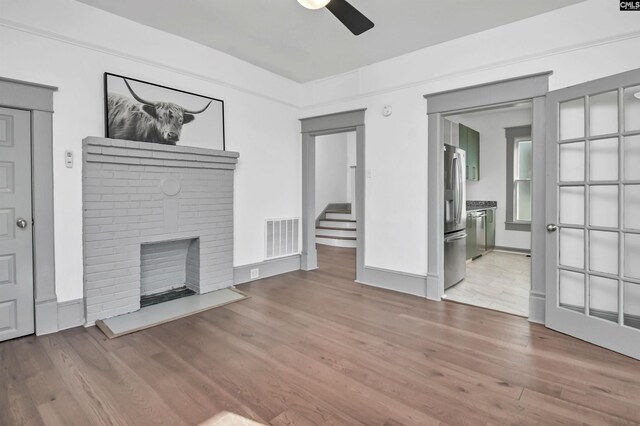 728 Laurel St, Columbia, SC 29201 - unfurnished living room with ceiling fan, wood finished floors, stairway, a fireplace, and baseboards