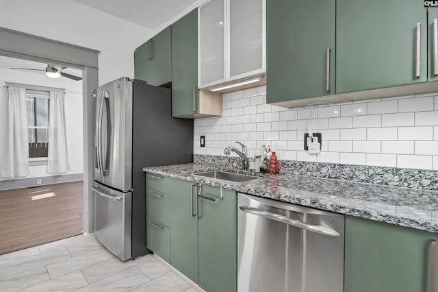728 Laurel St, Columbia, SC 29201 - kitchen featuring stainless steel appliances, green cabinetry, a sink, and decorative backsplash