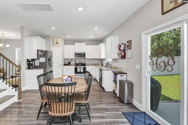 245 Long Iron Ct, West Columbia, SC 29172 - dining room featuring wood finished floors, stairway, recessed lighting, a chandelier, and baseboards