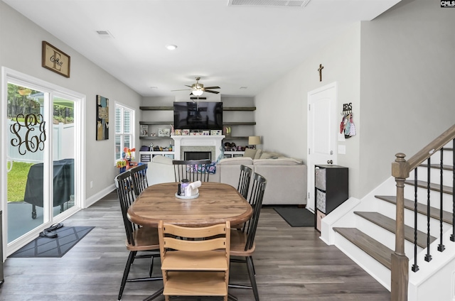 245 Long Iron Ct, West Columbia, SC 29172 - dining space with a ceiling fan, dark wood-style floors, stairway, a fireplace, and baseboards
