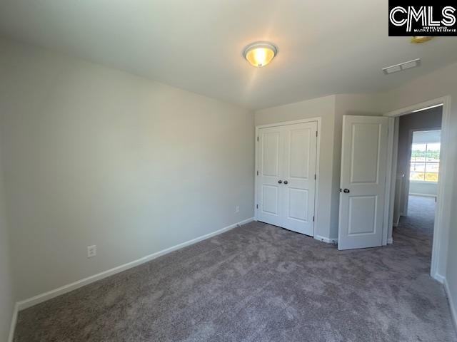 1023 Skyline Rd, Columbia, SC 29229 - unfurnished bedroom with carpet flooring, baseboards, and a closet