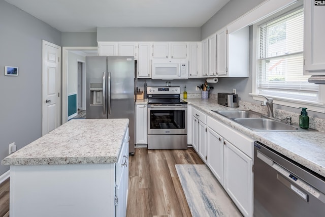 6 Hedgefield Ct, Irmo, SC 29063 - kitchen featuring stainless steel appliances, a sink, wood finished floors, and white cabinetry