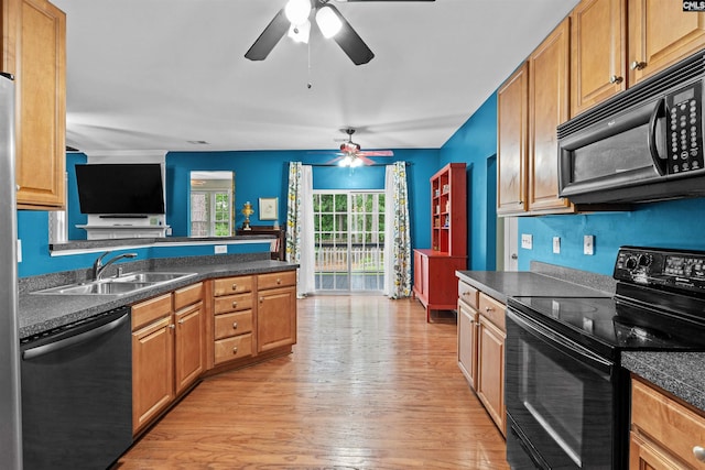 306 Austree Dr, Columbia, SC 29229 - kitchen featuring black appliances, a ceiling fan, dark countertops, a sink, and light wood-type flooring