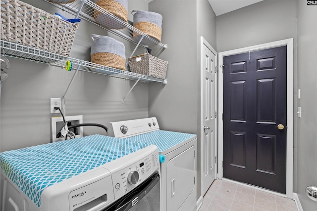 306 Austree Dr, Columbia, SC 29229 - laundry area with separate washer and dryer, light tile patterned floors, and baseboards