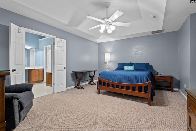 306 Austree Dr, Columbia, SC 29229 - bedroom featuring a tray ceiling, light colored carpet, baseboards, ensuite bath, and a ceiling fan