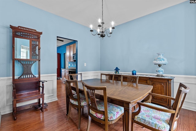 306 Austree Dr, Columbia, SC 29229 - dining area featuring a wainscoted wall, a chandelier, wood finished floors, and a decorative wall