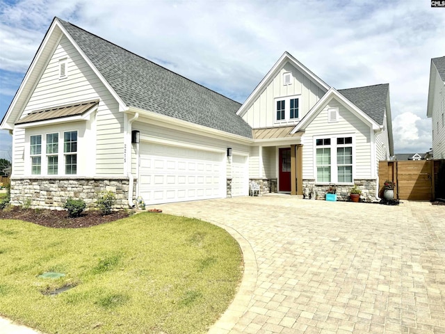 2215 High Bluff Loop, Lexington, SC 29072 - view of front of house with stone siding, board and batten siding, an attached garage, driveway, and roof with shingles