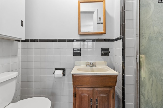 1514 Omarest Dr, Columbia, SC 29210 - full bath featuring tile walls, toilet, vanity, a stall shower, and a wainscoted wall