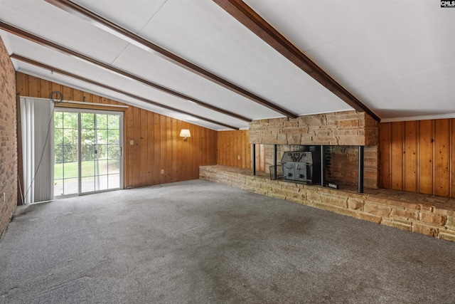 1514 Omarest Dr, Columbia, SC 29210 - unfurnished living room featuring wooden walls, a wood stove, and carpet flooring
