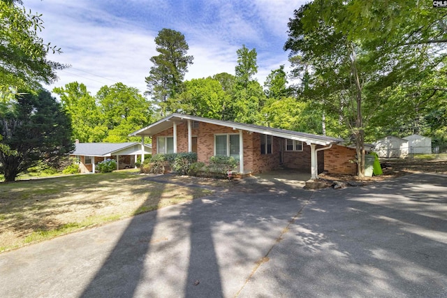 1514 Omarest Dr, Columbia, SC 29210 - view of front facade with asphalt driveway, brick siding, and a carport